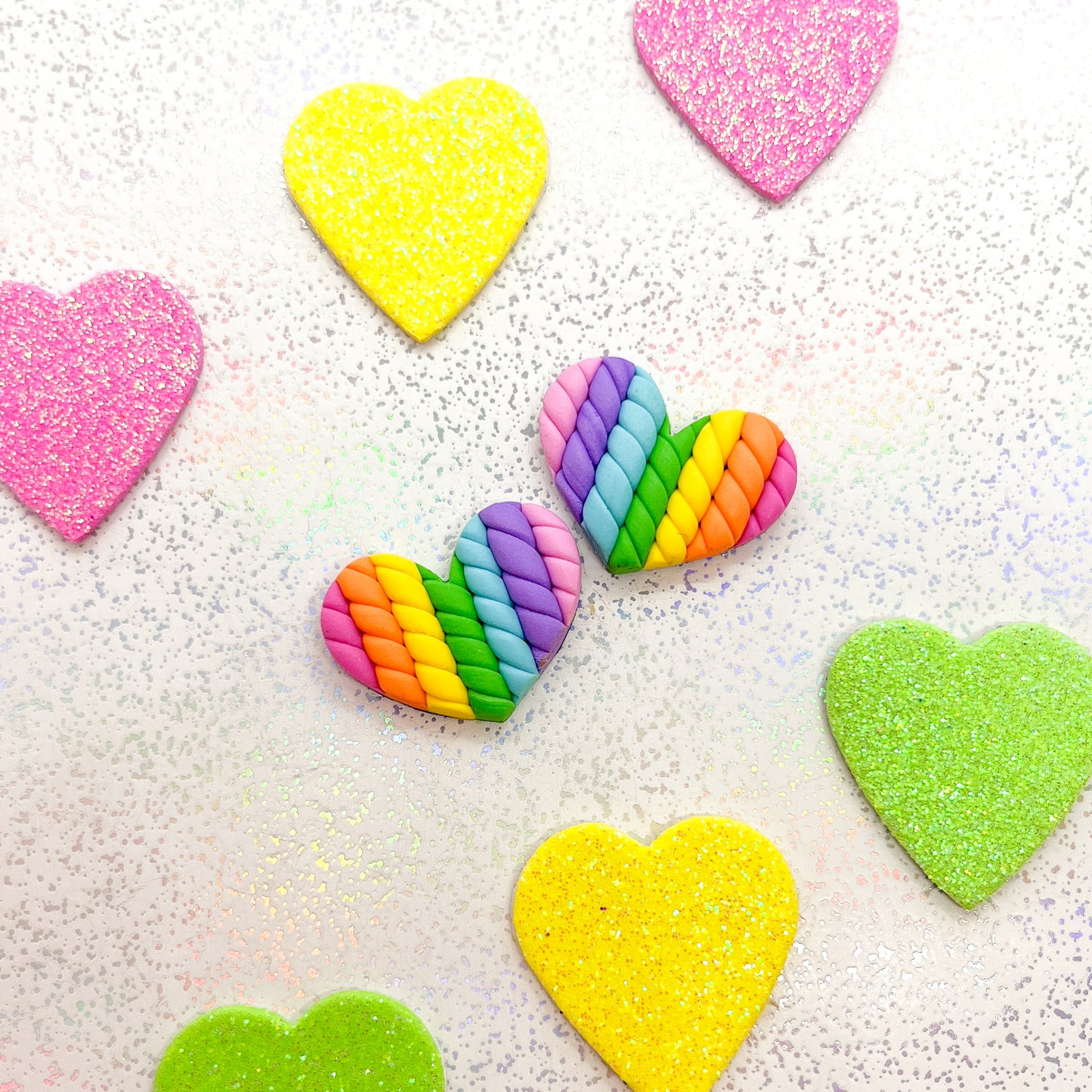 Vivid rainbow twisted heart studs