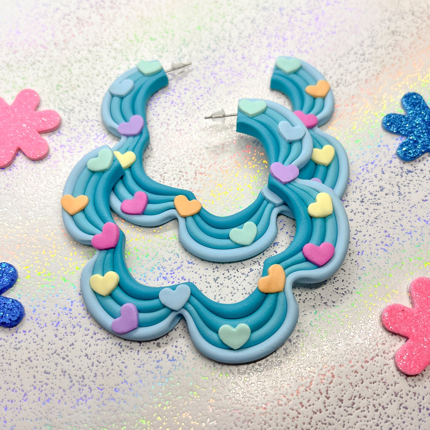 Blue ombre squiggle hoops with rainbow heart details