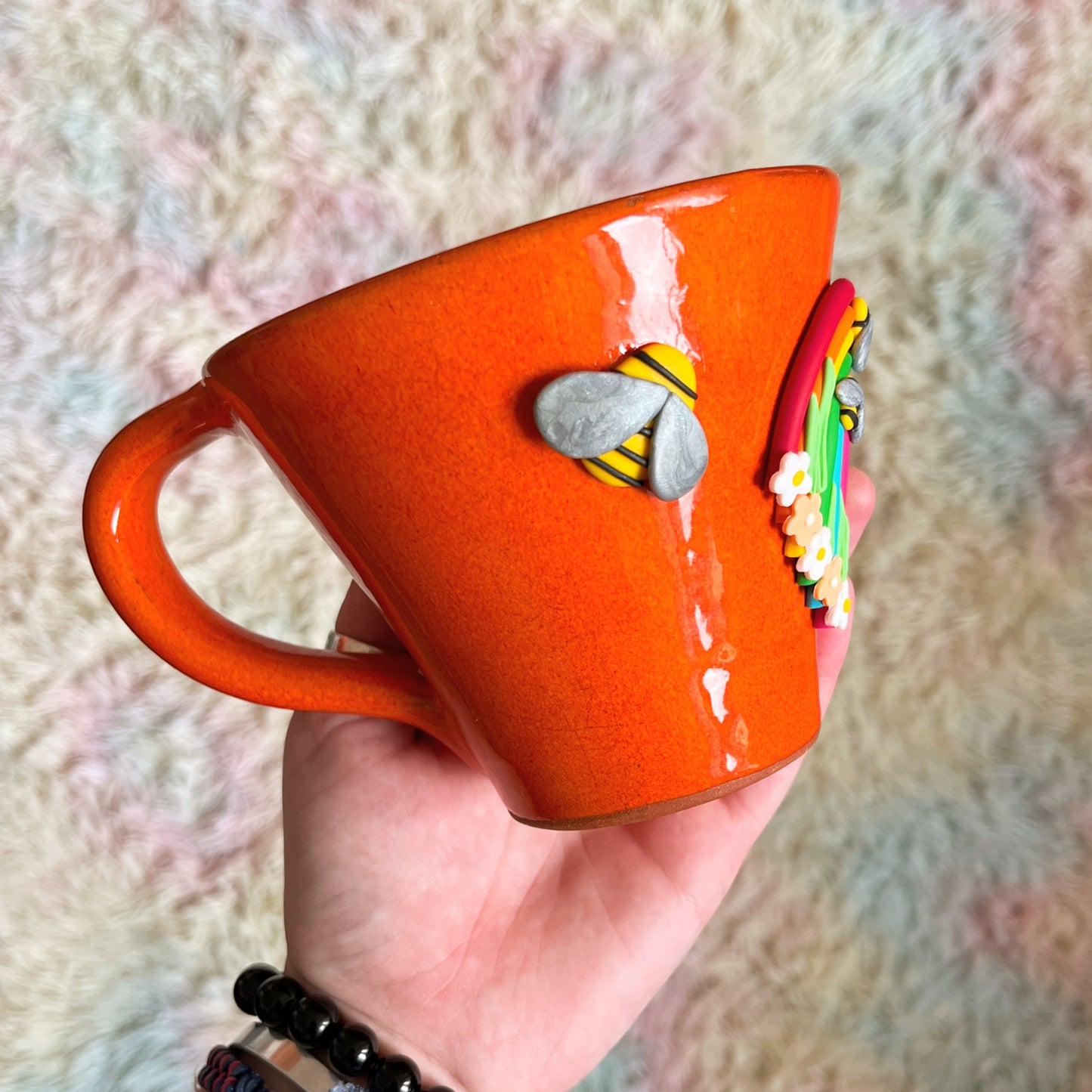 Vivid orange rainbow and bumblebee mug