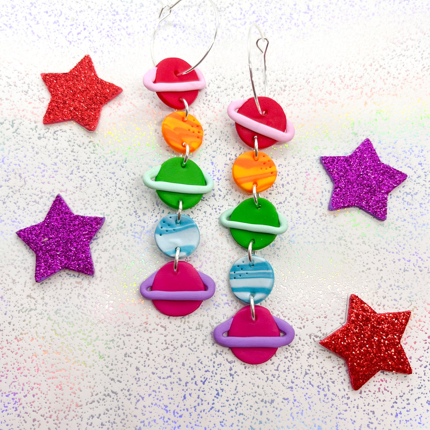 Bright rainbow cosmic planet dangles