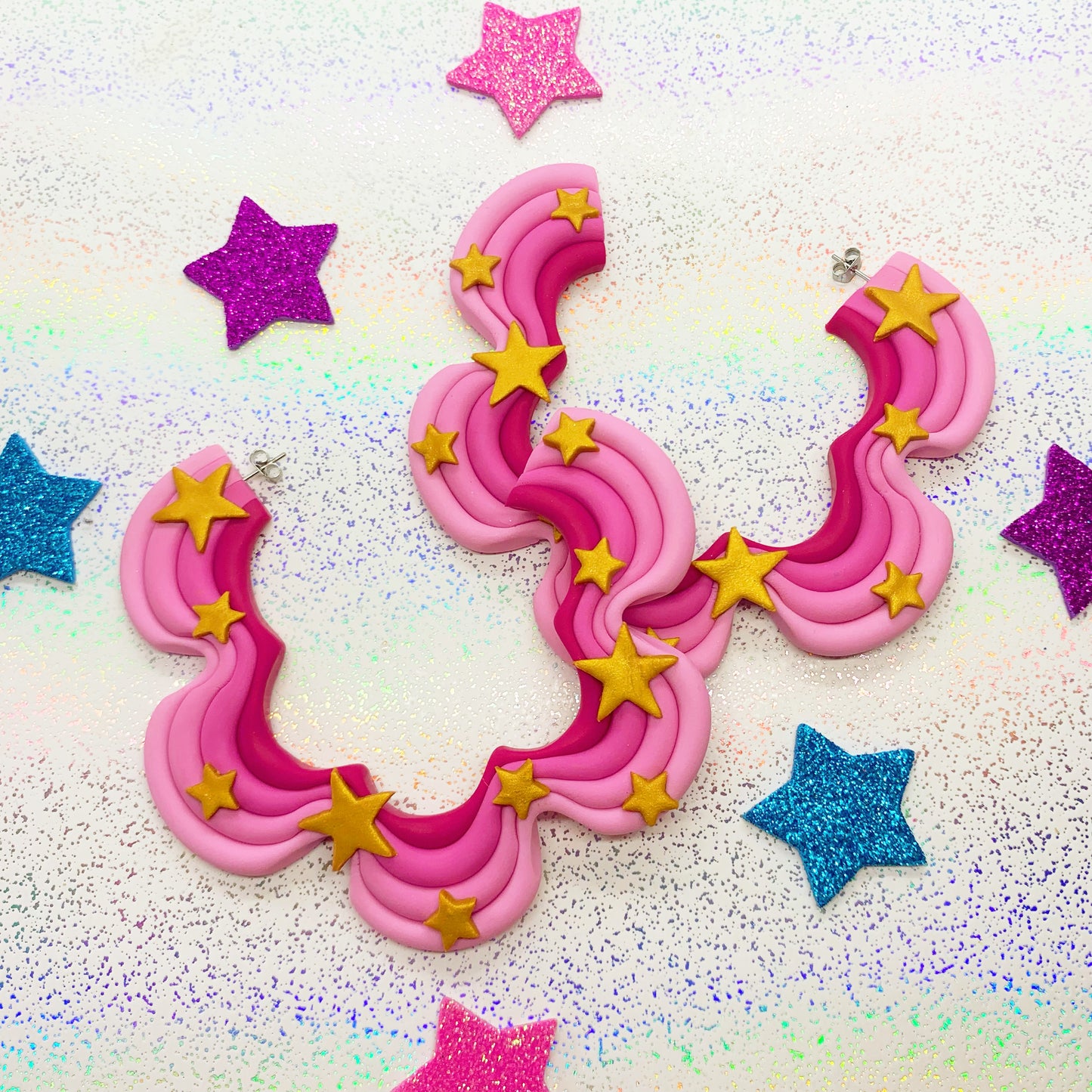 Pink squiggle hoops with gold star details