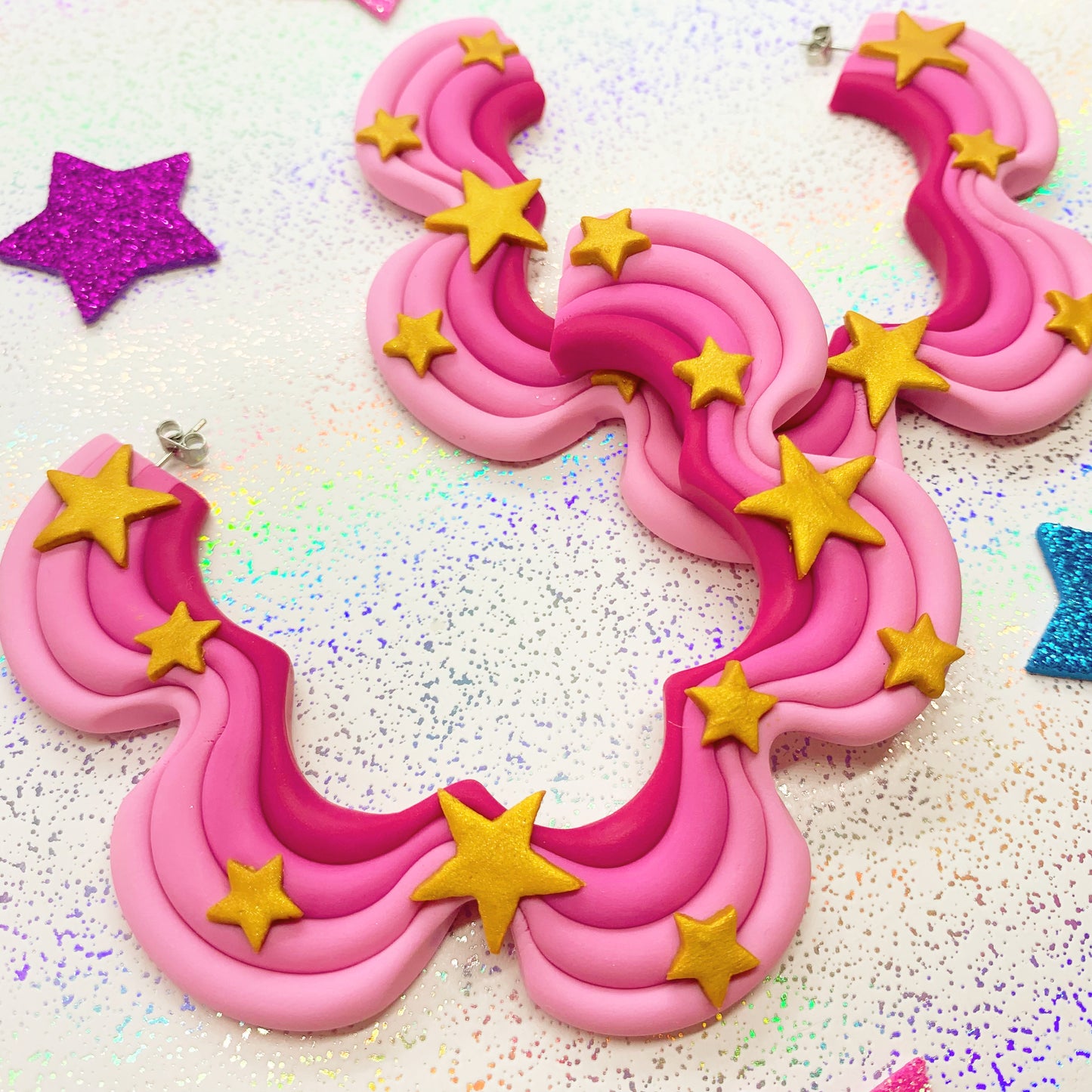 Pink squiggle hoops with gold star details